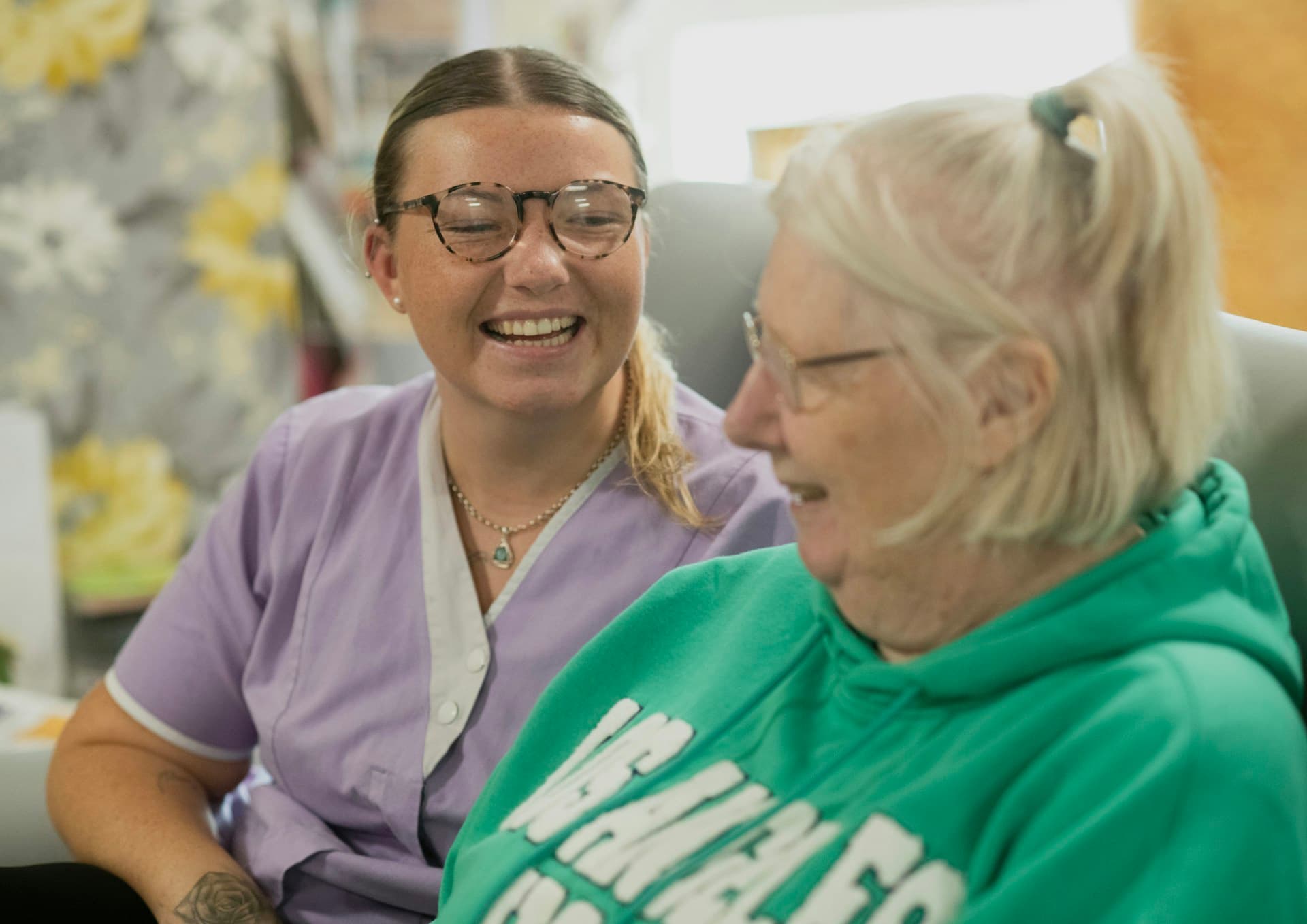 CNA and patient sharing a warm laugh together at home